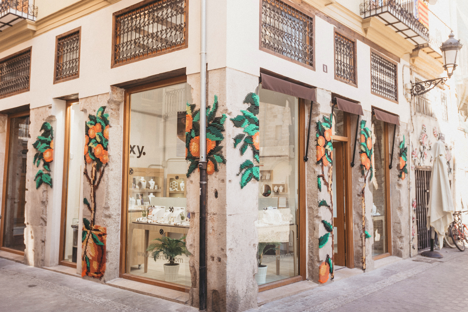 Anartxy jewellery shop — embroidered orange trees on facade Valencia old town corner