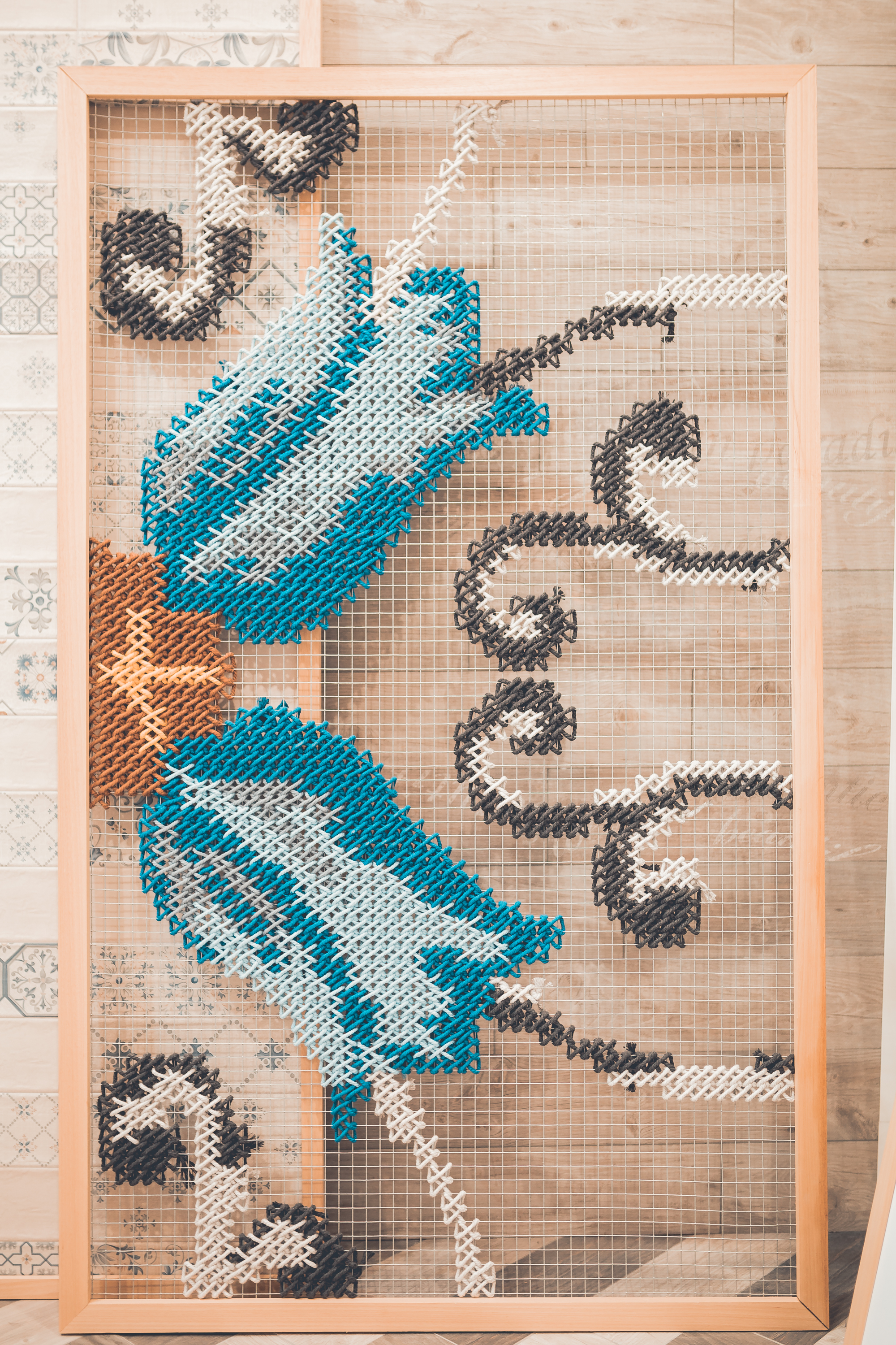 Gayafores — embroidered panel with blue and black tile motif framed